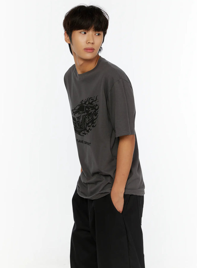 Men's Graphic Car Print T-Shirt IL513 Dark gray side shot on model gazing left showing flame car graphic cotton fabric drape with black trousers