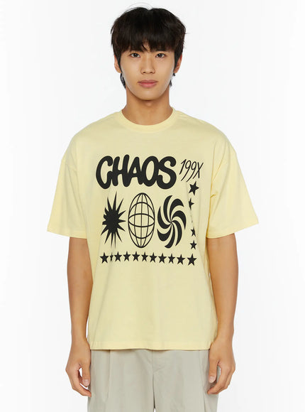 Men's Graphic Chaos T-Shirt IL509 Light yellow front close-up crop shot on male model showing black CHAOS 199X graphic with star globe swirl print detail