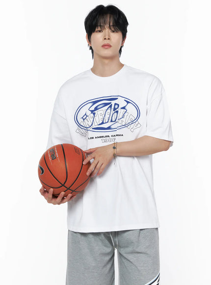 LEWKIN Men's Graphic Oversized T-Shirt IL502 White M/L front shot on male model holding basketball, blue oval logo graphic print, crew neck, styled with gray shorts