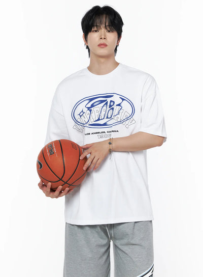 LEWKIN Men's Graphic Oversized T-Shirt IL502 White M/L front shot on male model holding basketball, blue oval logo graphic print, crew neck, styled with gray shorts