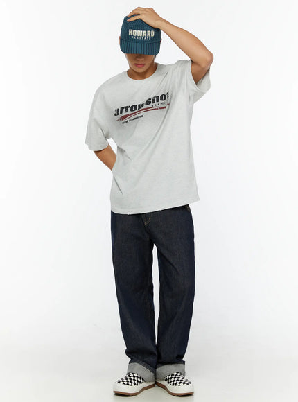 Men's Graphic Oversized T-Shirt IL515 Light Gray full-body front shot on male model one hand adjusting beanie cap styled with dark wide-leg jeans and slip-ons