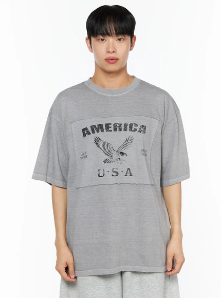 Men's Graphic Oversized Tee IL510 Grey front close-up on male model showing distressed America USA eagle graphic black print and raw-edge panel seam detail