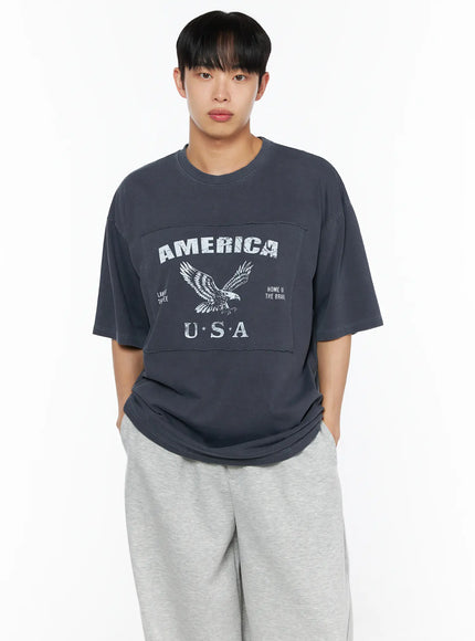 Men's Graphic Oversized Tee IL510 Dark blue close-up front bust shot on male model highlighting America USA eagle graphic and raw-edge horizontal panel seam
