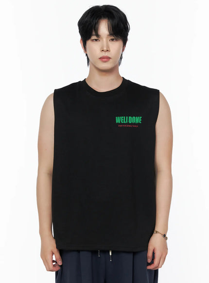 Men's Graphic Print Sleeveless Tee IL502 Black front close-up shot on male model showing green WELLDONE chest graphic on oversized cotton sleeveless tee