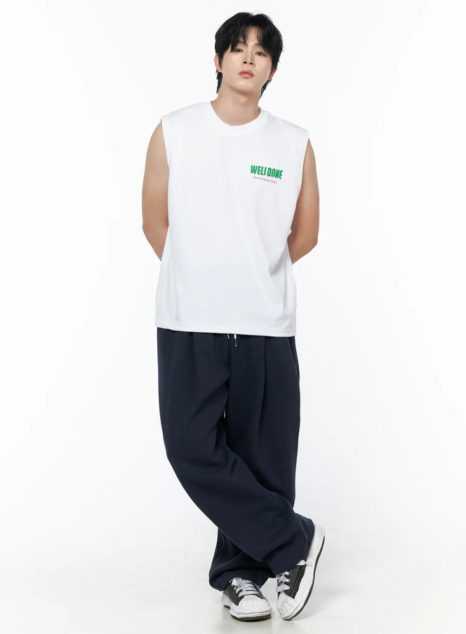 LEWKIN Men's Graphic Print Sleeveless Tee IL502 White front shot on male model angled pose with navy wide-leg trousers and sneakers