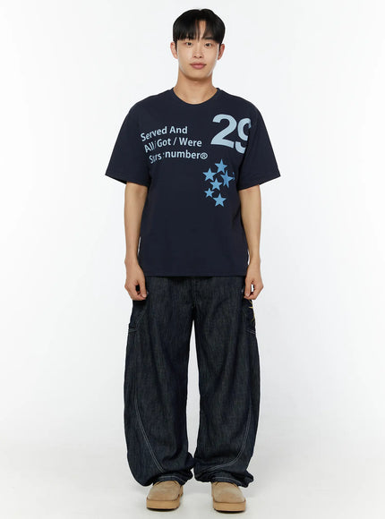 Men's Graphic Print T-Shirt IU529 Navy front full-body shot on male model standing straight, showing Served And All Got Were Stars:number® graphic and star cluster print