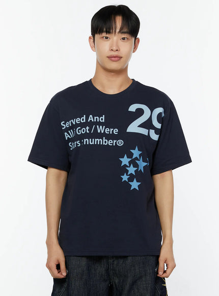 Men's Graphic Print T-Shirt IU529 Navy close-up front shot on male model from chest up showing Served And All Got Were Stars:number® 29 graphic print and crew neck detail