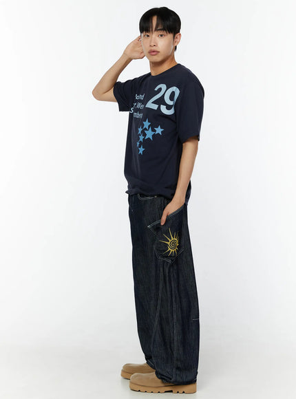 LEWKIN Men's Graphic Print T-Shirt IU529 Navy side shot on male model with hand raised, featuring bold 29 numeral and star print, styled with dark denim