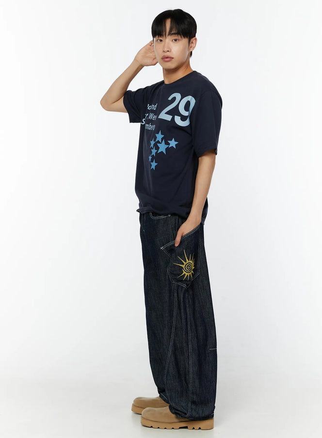 LEWKIN Men's Graphic Print T-Shirt IU529 Navy side shot on male model with hand raised, featuring bold 29 numeral and star print, styled with dark denim