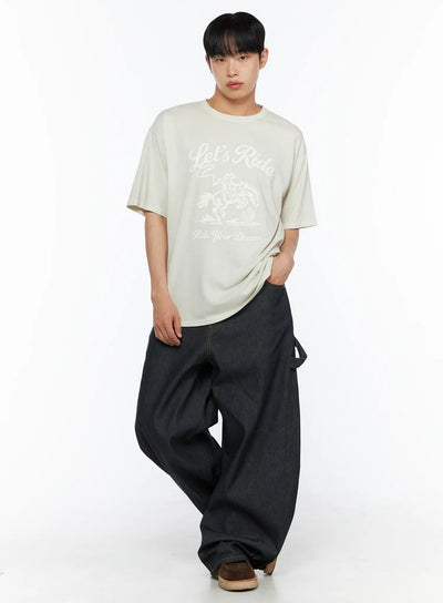 LEWKIN Men's Graphic Print Tee IL510 Light beige front full-body shot on male model standing with hand in pocket styled with dark wide-leg denim
