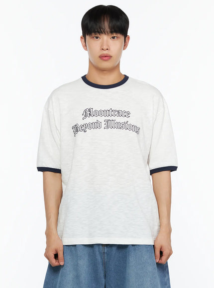Men's Graphic Ringer T-Shirt IL510 White front cropped shot on male model highlighting Moontrace Beyond Illusions gothic print, navy ringer collar and cuffs, slub texture