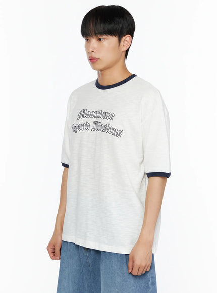 Men's Graphic Ringer T-Shirt IL510 White side close-up on male model showing Moontrace Beyond Illusions gothic chest print and navy contrast sleeve cuff detail