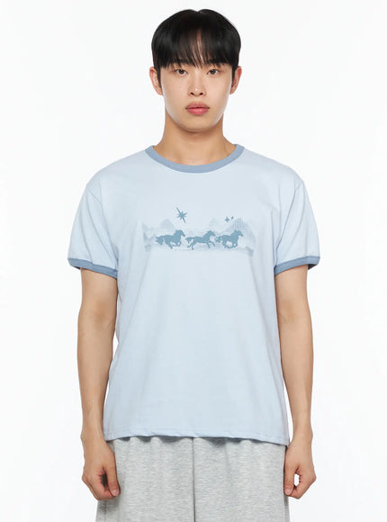 Men's Graphic Ringer Tee IL514 Light blue close-up front crop shot on male model, teal contrast crew neck and sleeve trim, running horse graphic with star motif detail
