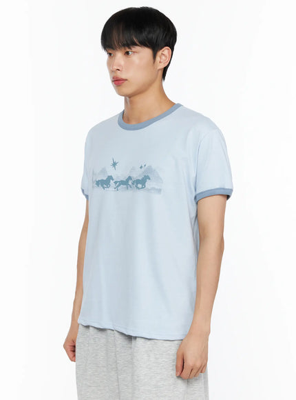 Men's Graphic Ringer Tee IL514 Light blue side shot on male model turned slightly left, horse silhouette chest graphic and contrast teal sleeve trim visible