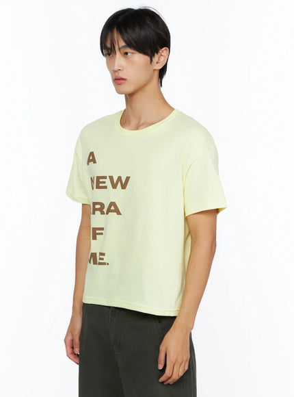 Men's Graphic Semi-Crop T-Shirt IL528 light yellow side shot on male model angled left revealing cropped hemline short sleeve and clean shoulder seam detail