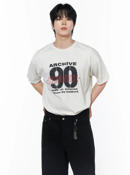 Men's Graphic Short Sleeve T-Shirt IU523 Light beige front mid-shot on male model with hands behind back showing ARCHIVE 90 RESONATE graphic and crew neck