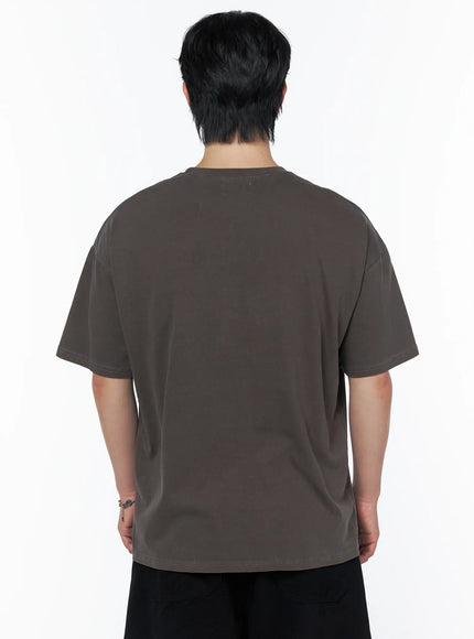 Men's Graphic Short Sleeve T-Shirt IU523 dark brown back view on male model showing plain clean back panel and relaxed oversized fit