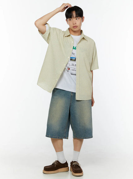Men's Graphic Short Sleeve T-Shirt IU529 White styling shot on male model layered under open plaid shirt with denim shorts and brown oxford shoes