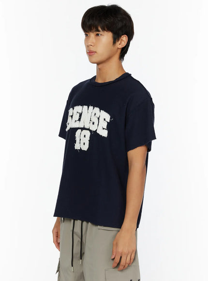 Men's Graphic Slogan T-Shirt IL509 Dark blue side shot on male model showing distressed raw-edge sleeve seams and relaxed cropped silhouette