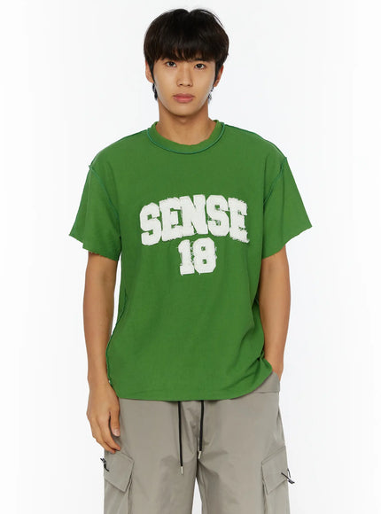 Men's Graphic Slogan T-Shirt IL509 Green front full-body shot on male model standing straight showing white SENSE 18 flocked graphic and raw-cut hem