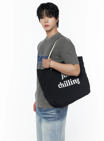 Men's Graphic Star T-Shirt IU523 Gray side shot on male model carrying black canvas tote bag over shoulder, blue star graphic visible on chest