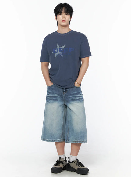 Men's Graphic Star T-Shirt IU523 Blue full-body front shot on male model, hands in pockets, styled with wide-leg denim shorts and chunky sneakers