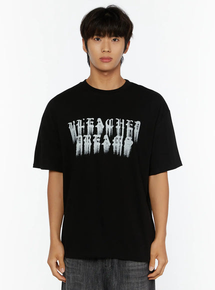 Men's Graphic T-Shirt IL515 Black cropped front close-up on male model, oversized crew-neck tee with large distressed gothic Bleached Dreams graphic print on chest