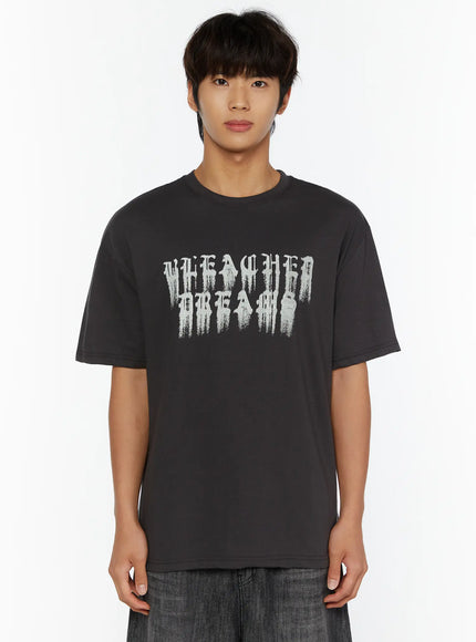 Men's Graphic T-Shirt IL515 Charcoal cropped front close-up on male model, bold distressed gothic Bleached Dreams graphic print detail on chest, crew neck