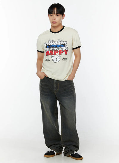 LEWKIN Men's Graphic T-Shirt IU529 Light beige front view on male model hands in pockets styled with dark wide-leg jeans black ringer collar and cuffs bear HAPPY print
