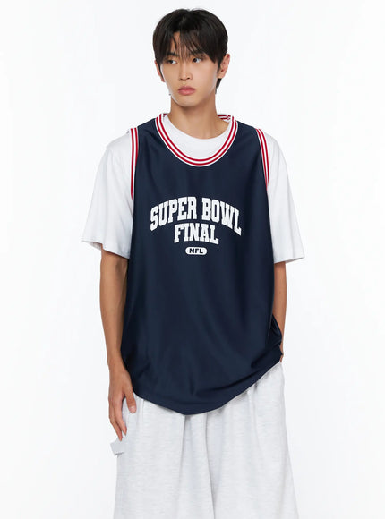 Men's Graphic Varsity Jersey IL515 Dark blue close-up front shot on male model cropped at waist, highlighting Super Bowl Final NFL arch print and red stripe neckline