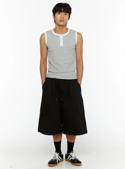 Men's Graphic Wide Jorts IL510 Black flat-lay front view showing elastic drawstring waistband, double cargo pockets, and hem drawcord details