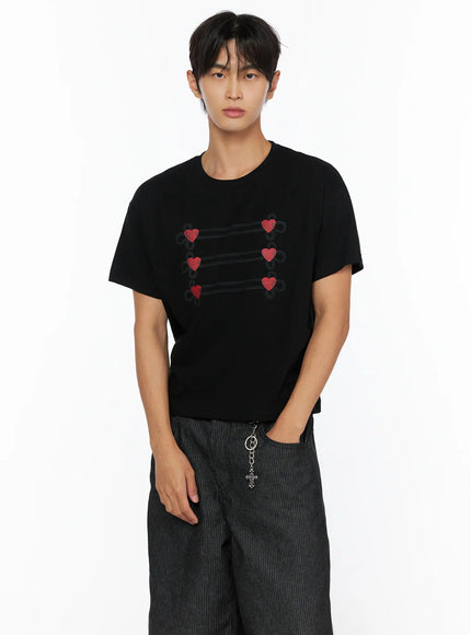 Men's Heart Graphic T-Shirt IL515 Black front shot on male model cropped view showcasing red heart loop graphic on black cotton fabric