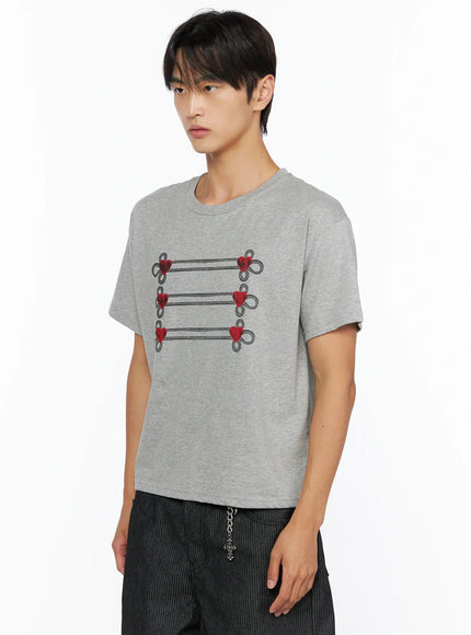 Men's Heart Graphic T-Shirt IL515 Gray side shot on male model three-quarter angle highlighting heart loop embroidery detail and relaxed fit