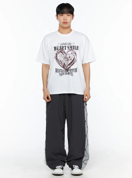 Men's Heart Graphic Tee IL514 White front shot on male model standing straight, oversized cotton tee with HEART SMILE grunge graphic and BEAUTIFUL ADVENTURE text print