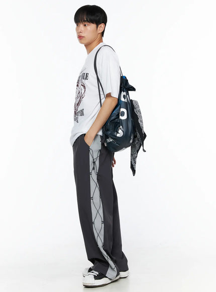 Men's Heart Graphic Tee IL514 White full-body side shot on male model with hand in pocket showing side profile, oversized silhouette with grunge heart graphic and drawstring bag
