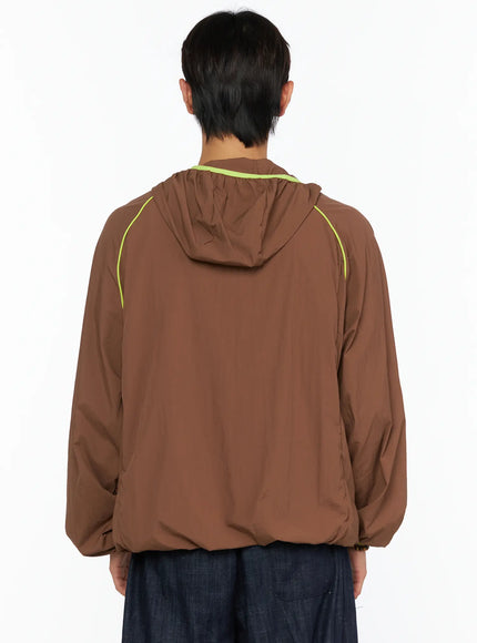 Men's Hooded Windbreaker IL528 Brown back shot on model, gathered hood with neon yellow trim, raglan sleeve seam piping, relaxed silhouette