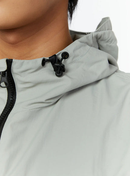 Men's Hooded Zip-Up Vest IL513 Gray close-up detail of elasticated drawstring hem with black cord stopper and side zipper