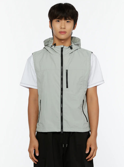 Men's Hooded Zip-Up Vest IL513 Gray front shot on male model standing straight arms relaxed showing zip-up closure and nylon texture