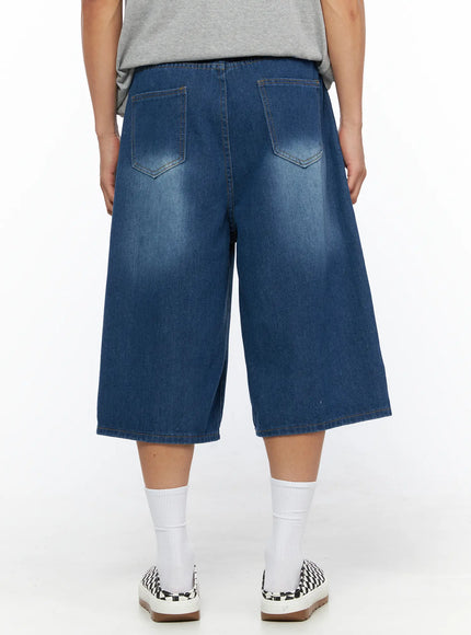 Men's Keyring Detail Jorts IL515 blue back shot on model showing two patch pockets with chevron stitching wide-leg silhouette and washed blue denim texture