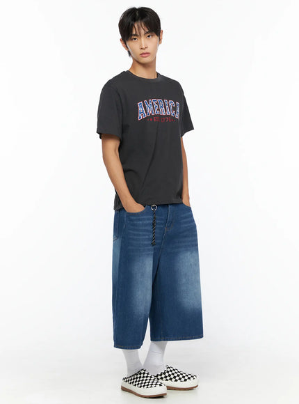 Men's Keyring Detail Jorts IL515 blue three-quarter angle full-body shot on male model with hands in pocket styled with charcoal America graphic tee and checkerboard sneakers