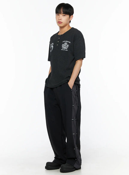 Men's Lace-Up Track Pants (Black) IL514 Black full-length side-angle shot on male model styled with dark graphic henley tee and chunky black boots