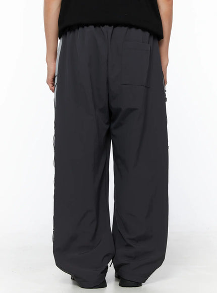 Men's Lace-Up Track Pants (Dark Gray) IL514 dark gray back shot on model showing elastic waistband, back welt pocket, and wide-leg silhouette with side lace panel