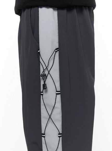 Men's Lace-Up Track Pants (Dark Gray) IL514 dark gray detail close-up shot of hem area showing adjustable drawstring toggle, lace cord, and gray contrast panel at ankle