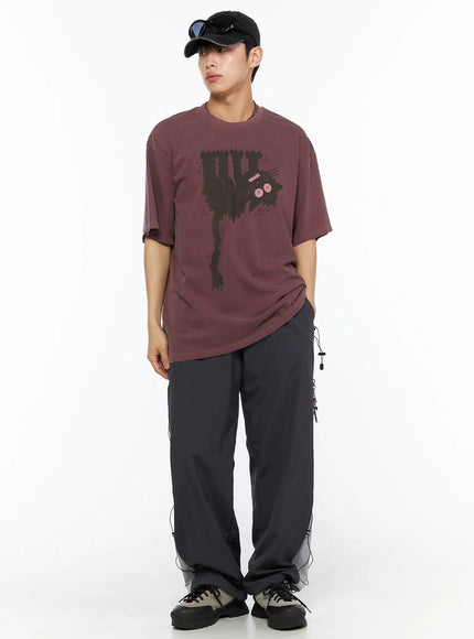 Men's Lace-Up Track Pants (Dark Gray) IL514 dark gray full-length front shot on model in burgundy graphic tee and cap, standing with hand at side showing chain accent and lace detail