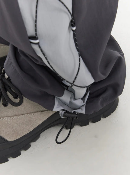 Men's Lace-Up Track Pants (Dark Gray) IL514 dark gray close-up detail shot of side lace-up cord and toggle stopper hardware on reflective gray panel