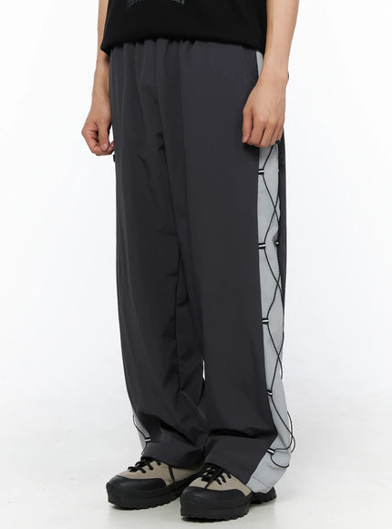 Men's Lace-Up Track Pants (Dark Gray) IL514 dark gray side close-up shot on model showing left leg lace-up cord panel and reflective gray strip detail