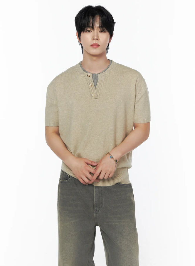 LEWKIN Men's Layered Henley Neck Knit Tee IL502 Beige front shot on male model hands clasped standing pose with gray contrast ribbed collar and gold buttons styled with gray wide-leg jeans