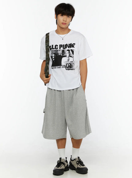 Men's Lettering Bermuda Shorts IL513 Gray full-length front view on male model, camo crossbody bag, white graphic tee, wide-leg bermuda shorts, relaxed street style look