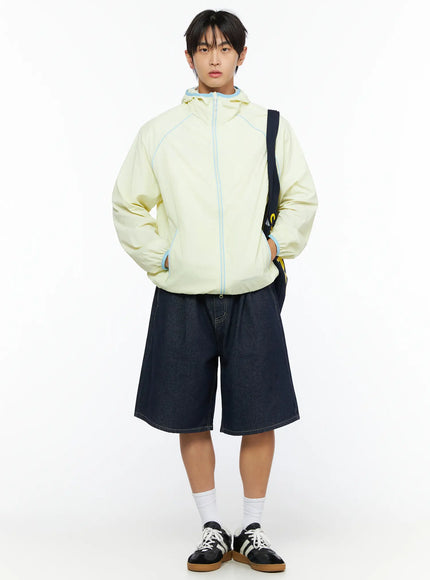 Men's Lightweight Windbreaker IL528 Light yellow front full-body on model styled with denim shorts, crossbody bag, and sneakers