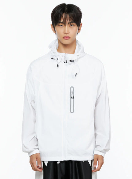 Men's Lightweight Windbreaker Jacket IL515 White cropped front shot on male model showing hood drawstring toggles and reflective oval chest pocket detail